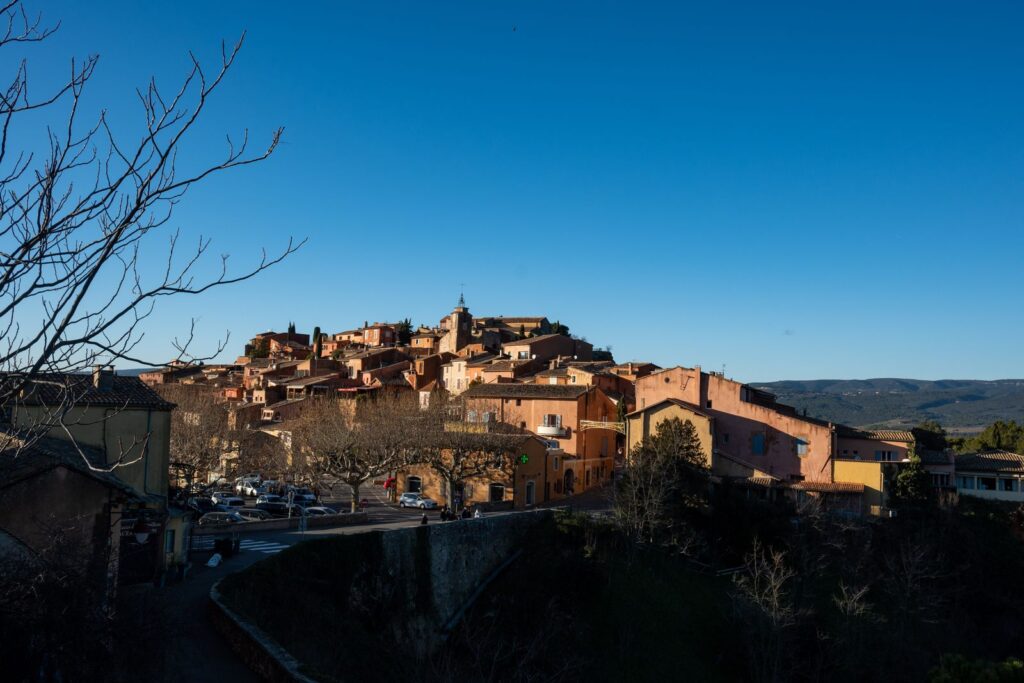 Les maisons ocre du village de Roussillon, dans le Luberon, sous un ciel bleu.